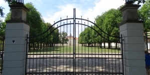 Pałac Raczyńskich w Rogalinie - widok przez zamkniętą bramę wjazdową.